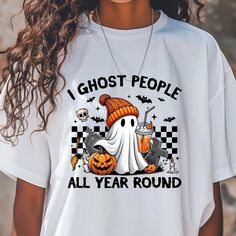 A spooky fall-themed T-shirt that reads 'I Ghost People All Year Long'. This Comfort Colors 1717 tee in multiple sizes from S to 4XL is perfect for Halloween enthusiasts and those who love all things ghostly. The garment-dyed fabric provides a soft color and texture, while the double-needle stitching ensures durability. With a relaxed fit and classic crew neckline, this tee is versatile for casual or semi-formal settings. Product features - Available in S to 4XL for the perfect fit - Double-need Horror Themed Short Sleeve T-shirt For Fall, Funny White T-shirt For Fall, Spooky Pre-shrunk T-shirt For Fall, Horror Style Short Sleeve T-shirt For Fall, Spooky Short Sleeve T-shirt For Fall, Fall Novelty T-shirt With Funny Print, White Horror T-shirt For Fall, Horror Themed Letter Print Crew Neck T-shirt, Funny Print Novelty T-shirt For Fall