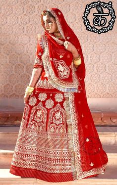 a woman in a red and white bridal dress