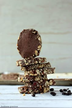 chocolate cookies stacked on top of each other with raisins scattered around the edges