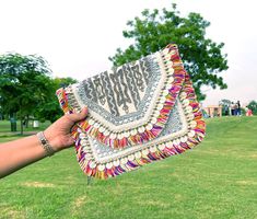 Trendy Jaipuri Boho Sling Bag Boho Handcrafted Jute Bag, Banjara Bag, Designer Bag, Bohemian Bag, Coin Bags, Shell Jute Bag clutch, Christmas Gift, Gift, Bag, Sling Bag Made by local Women Artisans Material: Eco-Friendly Jute Material Boho coin bags with cotton fringes  Dimension : Height 10" x Length 13" Disclaimer : Product color slightly vary due to photogenic effect Bohemian Clutch Bag With Tassels, Bohemian Tassel Clutch Bag, Everyday Festival Clutch Shoulder Bag, Festive Beige Rectangular Shoulder Bag, Handmade Beige Shoulder Bag For Festivals, Rectangular Tasseled Bags As Gifts, Rectangular Tassel Bags Perfect For Gifts, Festival Bags With Tassels As Gifts, Bohemian Shoulder Bag With Tassels As Gift