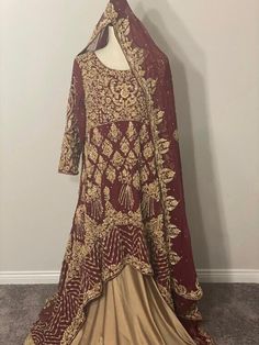 Pure Chiffon A line shirt with high low style and 4 -5 ft tail at the back.  Full Golden Zari Dardoz with Kora-dabka work and chan boutiee.  Bridal Dupatta with Matha patti one side and 3 side 4 inch zari dardoz work border.  Velvet shawl with Kora Dabka borders and corner bunches. Maroon Bridal Dress, Tail Lehenga, Golden Lehenga, Pakistani Bridal Dress, Matha Patti, Bridal Dupatta, Zardozi Work, Latest Bridal Dresses, Velvet Shawl