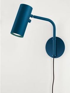 a blue wall light with a black cord attached to the arm and a white wall behind it