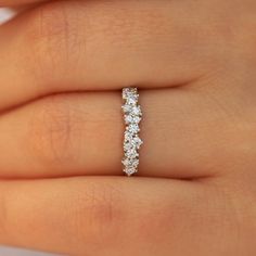 a woman's hand with a diamond ring on it