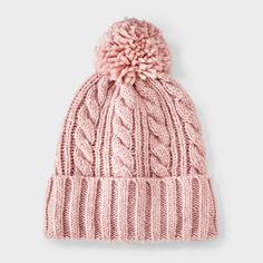 a pink hat with a pom - pom