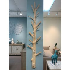 two wooden sculptures are on display in a room with blue walls and white ceilinging