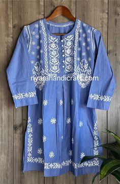 Unique denim look Chikankari hand embroidered blouse with side slits. Length: 32 inches Luxury Elegant Embroidered Top With Chikankari, Indigo Kurta With Chikankari Embroidery For Festivals, Traditional Indigo Embroidered Kurta, Traditional Embroidered Indigo Kurta, Indigo Kurta With Chikankari Embroidery And Long Sleeves, Traditional Indigo Kurta With Chikankari Embroidery, Traditional Indigo Kurta With Floral Embroidery, Blue Embroidered Straight Kurta Top, Indigo Long Sleeve Kurta With Floral Embroidery