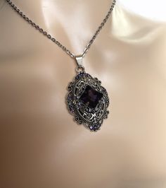 "This richly detailed antiqued silver plated filigree pendant, is adorned with dazzling VIOLET PURPLE glass rhinestones that perfectly accentuate a larger jewel in the center. Pendant measures 2 1/4\" tall (including the bail) and 1 1/4\" wide. It is worn on a cable chain in your choice of length and fastens with a lobster clasp. Listing is for necklace ONLY. Matching earrings are listed in our store. This is available in a variety of stone colors in our store, along with matching earrings. If y Antique Jeweled Silver Necklace, Antique Silver Jeweled Necklace, Antique Silver Jeweled Necklaces, Vintage Silver Rhinestone Pendant Necklace, Antique Jeweled Silver Jewelry, Silver Victorian Necklace For Party, Antique Silver Jeweled Jewelry, Metal Rhinestone Pendant Necklace For Wedding, Wedding Rhinestone Pendant Necklace