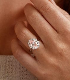 This exquisite 2-carat pink diamond oval halo engagement ring is a true masterpiece of fine jewelry. The captivating pink diamond, a rare and stunning gemstone, takes center stage, surrounded by a dazzling halo of smaller diamonds. The delicate band, crafted with meticulous attention to detail, adds a touch of elegance and sophistication. This ring is not just a piece of jewelry; it is a symbol of eternal love and commitment. Its timeless design and exquisite craftsmanship make it a treasured heirloom, destined to be passed down through generations. Key Features: 2-carat pink diamond: A rare and beautiful gemstone Diamond halo: Enhances the brilliance of the center stone Delicate band: Adds a touch of elegance 18K / 14k / 10k gold setting: Ensures durability and shine Timeless design: Perf Pink Diamond Engagement Ring Gold, Oval Diamond Halo Engagement Ring, Pink Diamond Engagement Ring, Oval Halo Engagement Ring, Pink Engagement Ring, Pink Diamond Ring, Gold Diamond Engagement Rings, Halo Engagement Ring, Diamond Halo