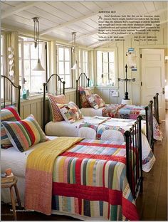 there are two beds in the room with quilts on them and pillows on the bed