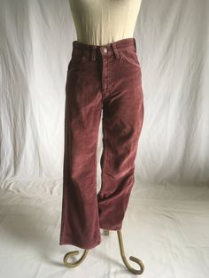 "vintage 1960s pants Levis, white tab big E Scovill zipper boot cut faded purple 4 pocket 7 belt loop cotton feel soft corduroy style has a velvet like feel good vintage condition w/some authentic age wear/frayed inseam to outer stitching, inner stitching good, small repair patchunder back of bottom belt loop-see photos measures,lying flat, waist-15\" rise-11\" hip-19\" inseam-30\" hem-9 1/2\" outseam-40\"" 70s Inspired Wide Leg Fall Bottoms, 70s Inspired Wide Leg Bottoms For Fall, 70s Inspired Wide Leg Pants For Fall, Vintage Non-stretch Bottoms With Pockets, Retro Cotton Bottoms For Fall, Retro Mid-rise Pants With Relaxed Fit, Retro Straight Leg Pants For Fall, Retro Mid-rise Relaxed Fit Pants, Retro Cotton Pants For Fall