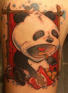 a panda bear eating food on the back of a woman's leg