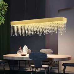 a dining room table with chairs and a chandelier hanging from the ceiling