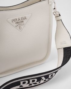 Detachable adjustable 95 cm embroidered logo-print woven tape shoulder strap Detachable adjustable 100 cm leather shoulder strap Metal hardware Metal lettering logo on the front Magnetic closure Logo print nylon lining with card slots Shoulder Bag Prada, Prada Re Edition 2005, Mini Hobo Bag, Large Leather Handbags, Tape Shoulder, Prada Mini, Metal Lettering, Prada Re Edition, Plastic Trash