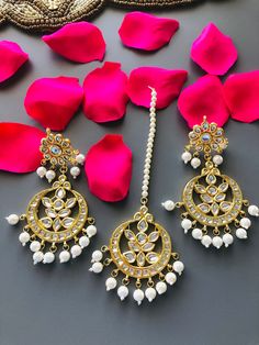 Kundan Chandbali Mang Tika Combo set/Kundan Chandbali/Kundan Mang Tika Features: 1- Base Metal Brass 2- Very high quality Kundan Stones 3- Length: Mang Tika- 7 Inches Earrings- 3.75 Inches 4- Traditional Earrings and Mang Tika Combo Set 5- Earrings come with Push Back closure Traditional Hand Set Chandbali Sets, Traditional Chandbali Jewelry Set With Latkans, White Hand Set For Festivals, Kundan Chandbali Jewelry Set For Rituals, Festival Chandbali Jewelry Set For Puja, Gold Bollywood Sets For Rituals, Bollywood Style Gold Sets For Rituals, Traditional Meenakari Sets For Rituals, Kundan Chandbali Sets For Puja