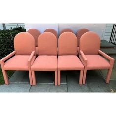 three pink chairs sitting next to each other