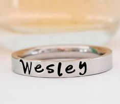 Petite name ring. Stacking name ring. Personalized name ring. This GOREOUS 3 mm ring is super shiny. Great for stacking. The surface is flat, so the lettering really stands out! Add names, initials, dates, quotes, roman numerals or scripture. I have the heart, double heart, infinity, #, &, @, !, =, *, :, ?, cross, baby foot, angel, and ribbon stamps. 15-character limit. Made of solid surgical Stainless steel which will never rust, tarnish, change color and is hypoallergenic. Swim & shower safe! Dates Quotes, Infinity Cross, Ring Name, Stacked Rings, Name Ring, Name Rings, Personalized Ring, Ring Stacking, Double Heart