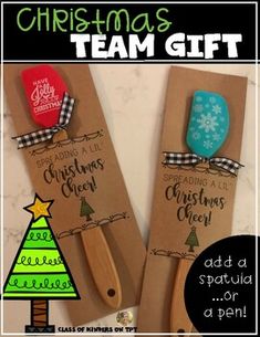 two wooden spatulas with christmas themed designs on them, sitting next to each other