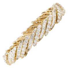 18K yellow gold bracelet featuring both round and baguette diamonds. There are 84 round diamonds totaling 9.8 carats and 196 baguette diamonds totaling 4.2 carats. Total diamond weight is 14 carats; H-I color and VS-SI clarity. Measures 7 inches long and 7/16 inches wide. Closure is hinged with a figure eight safety. Buccellati Bracelet, Round Diamond Bracelet, Blue Sapphire Bracelet, Diamond Bangles, 18k Gold Bracelet, Gold Link Bracelet, White Gold Sapphire, Floral Bracelet, Diamond Bangles Bracelet