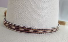 Cowboy hat band, genuine horsehair hat band, Five Strands wide ( 5/8 inch) BOLDLY done in a a natural brown-rich black and off-white Double horse hair tassels, Oh So Stetson perfect, **VERY Distinctive look **OUTSTANDING QUALITY ** STETSON perfect ** LUXURIOUS 100% genuine horsehair ** 5/8 inch wide. You will quickly discover that nothing compares to this extraordinary beauty: This horsehair hat band DEMANDS attention. This beauty is a 5 strands wide. Each strand is about 1/8 inch wide, separate Classic White Hat Bands For Rodeo, Classic White Hat Band For Rodeo, White Fedora Panama Hat For Ranch, Adjustable Cream Panama Hat For Ranch, White Brimmed Hat Bands For Rodeo, White Southwestern Hat For Western-themed Events, White Adjustable Panama Hat For Western-themed Events, White Southwestern Short Brim Hat, Elegant White Panama Hat For Country Events