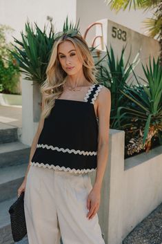 Front view of Sadie Textured Tank in black with cream wavy trim details throughout. Fitted Black Tank Top With Lace Detail, Stretch Black Tank Top With Lace Detail, Sleeveless Black Ruffled Tank Top, Black Sleeveless Tank Top With Smoothing Details, Black Ruffled Cami Tank Top, Summer Dresses Shoes, Faux Leather Purse, Faux Leather Belts, Travel Dress