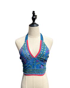 This vibrant, hand-embroidered bikini halter top offers stylish Boho-inspired fashion with its colorful threads and sequin embellishments. Paired with jeans or a skirt, this is the perfect summer top to stand out in and make a statement. The lining is a contrasting color to give it a unique, eye-catching look. One Size Made in India Care Instructions: Dry clean only Girl In The Mirror, Colorful Threads, Fur Purse, Inspired Fashion, The Mirror, Summer Top, Bright Orange, Perfect Summer, Bright Pink