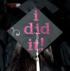 a graduation cap with the words i bid it written on it in pink glitter letters