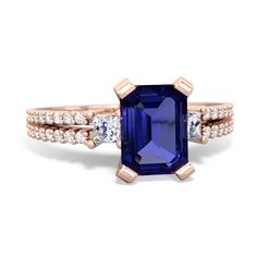 a blue sapphire and diamond ring set in rose gold with diamonds on the sides,