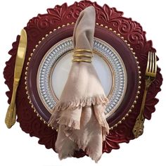 a plate with a napkin, fork and knife on it