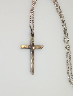 A hand-forged, hammered, sterling silver cross contrasts beautifully with a delicate, sparkling 2mm (I1) natural white diamond accent. Strung on an 18-inch sterling chain with a silver lobster claw clasp. Visit my necklace an pendant section for more handmade beauties: https://www.etsy.com/shop/MyFascinationStreet?section_id=16231287&ref=shopsection_leftnav_6 Visit my shop: www.etsy.com/shop/MyFascinationStreet Connect with me on... www.FascinationStreetDesigns.com Facebook: https://www.face Sterling Silver Diamond Cut Cross Pendant Necklace, Sterling Silver Cross Necklace With Diamond Cut, Sterling Silver Diamond Cut Cross Necklace, Sterling Silver Diamond Cut Pendant Cross Necklace, Silver Sterling Silver Cross Necklace With Diamond Cut, Sterling Silver Diamond Cut Silver Cross Necklace, Dainty Sterling Silver Cross Jewelry, Dainty Silver Crucifix Jewelry, Sterling Silver Cross Necklace For Wedding