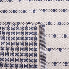 the blue and white pattern on this rug is made from woven fabric, which has been handwovened