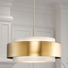 a white and gold chandelier hanging from a ceiling in a room with white walls