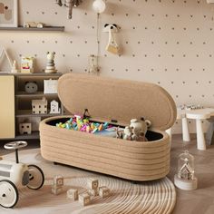 a toy chest filled with lots of toys on top of a hard wood floored floor