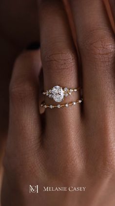 a woman's hand with a diamond ring on it