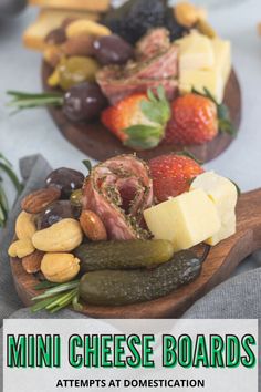 two wooden spoons filled with cheese and fruit