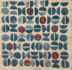 a piece of cloth with blue and red circles on it, in front of a white background