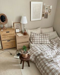 a bed room with a neatly made bed next to a night stand and nightstands