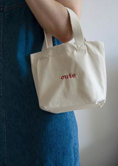 This small, personalized canvas bag is perfect for many occasions. Whether as a handbag for on-the-go, for quick errands, as a sustainable gift bag, or as a snack bag for kindergarten - it's practical and looks great. You can customize the small bag with embroidery however you like. Add a name, a special word, or even a small symbol of your choice. The bag is made of durable, 340 gsm organic cotton canvas. It features woven handles with a length of 34 cm for easy carrying. With a capacity of 4 l Everyday Bags With Embroidered Logo And Double Handle, Beige Bags With Embroidered Logo For Daily Use, Embroidered Canvas Bag For Everyday, Everyday Embroidered Canvas Bag, Beige Rectangular Canvas Bag With Embroidered Logo, Beige Shoulder Bag With Embroidered Logo For Everyday Use, Rectangular Beige Canvas Bag With Embroidered Logo, Everyday Tote Shoulder Bag With Embroidered Logo, Beige Canvas Tote Bag With Embroidered Logo