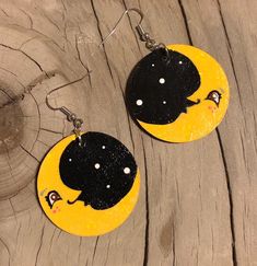 These novelty earrings are approximately 1.5 inches in diameter. Hand drawn and painted by Jeanine Each pair is one of a kind Quirky Handmade Yellow Earrings, Fun Hand Painted Yellow Earrings, Fun Yellow Hand Painted Earrings, Handmade Whimsical Moon Earrings, Whimsical Moon-shaped Handmade Earrings, Hand Painted Yellow Enamel Earrings, Hand Painted Yellow Artsy Earrings, Yellow Hand Painted Artsy Earrings, Artistic Hand Painted Yellow Earrings