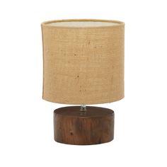 a wooden table lamp with a beige linen shade on the top and bottom part of it