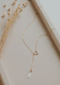 Our first clasp-less necklace! We're into it, and we know you will be too! Simply slide the stunning stone pendant through the triangle charm and adjust to your liking. Necklace measures 18". Stones range from 13mm-19mm long. Available in 14kt Gold Fill + Sterling Silver. Double loop the chain through triangle piece to secure it in place. Kayla layers it with a bold and classic Herra Chain. Kyra pairs it with our Mari Choker. Handmade in Eau Claire, WI. Our jewelry is handmade so each piece will Y Shaped Necklace, Long Gold Necklace, Twist Earrings, Choker Handmade, The Triangle, Jewelry Lookbook, Fantasy Jewelry, Dainty Earrings, Lariat Necklace