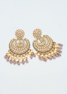 These Polki earrings are a classic addition to any traditional outfit with their stunning stones, crystals, and pearls. They add an exquisite charm and make for the perfect accessory to complete your look. Earrings length: Approx. 3.5" Weight of each earring: 31 gms Push-Back Closure. Antique Gold Plated on high-quality brass as the base metal In-stock & ready-to-ship Color may vary slightly due to light condition & photography. Jewelry Care: Keep away from moisture. Allow perfumes and lotion to Photography Jewelry, Phone Items, Polki Earrings, Traditional Outfit, Chandbali Earrings, Jewelry Pouch, Base Metal, Jewelry Care, Traditional Outfits