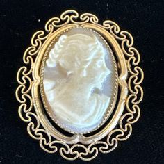 This vintage brooch and pendant combo is a unique addition to any jewelry collection. The intricate filigree design is made of 12k yellow gold filled metal, and features a beautiful oval-shaped shell cameo as the main stone. This piece is signed and comes from Italy, adding to its rarity. Perfect for those who appreciate fine jewelry, this brooch pendant can be worn on a variety of occasions. Its vintage charm and delicate details are sure to catch the eye of anyone who sees it. Add it to your c Antique Brooch With Intricate Pendant Design, Antique Pendant Brooch With Intricate Design, Antique Yellow Gold Brooches With Intricate Design, Ornate Engraved Yellow Gold Brooches, Ornate Carved Gold Brooches, Ornate Gold Carved Brooches, Victorian Gold Pendant Brooches, Carved Yellow Gold Brooches For Wedding, Antique Yellow Gold Filigree Brooches