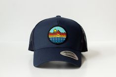 Mountains - Trucker Hat - Navy Blue 65/35 polyester/cotton Mesh back, structured Mid-profile, six-panel Snapback closure Blue Summer Trucker Hat For Travel, Summer Trucker Hat In Blue For Travel, Navy Summer Baseball Cap, Navy Travel Hat With Curved Brim, Summer Beach Six-panel Trucker Hat, Blue Six-panel Trucker Hat For Summer, Navy Baseball Cap For Summer Outdoor, Summer Trucker Hat Six-panel, Blue Cotton Trucker Snapback Hat