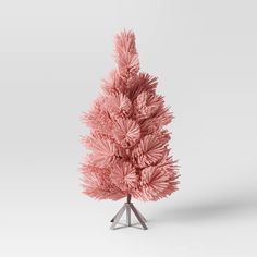 a pink christmas tree is shown on a white background