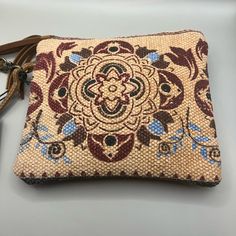 This Myra Bag Women's Canvas Purse In The "Lurantis" Pouch Style Is A Versatile And Stylish Addition To Any Outfit. With A Small Size Of 8.5" X 7.5", It Can Be Used As A Wristlet For Casual Occasions. The Bag Features A Beautiful Floral Pattern And Is Made Of Canvas And Leather Materials, With Gold Hardware Accents And A Brushed Finish. The Wrist Strap Is Brown In Color And Measures 5 Inches In Drop Length. The Bag Has A Zip Closure And Is Lined With Canvas And Leather Materials In A Brown Color Beige Handheld Pouch For Daily Use, Everyday Handheld Beige Pouch, Daily Use Beige Handheld Pouch, Daily Use Handheld Beige Pouch, Beige Tote Pouch For Daily Use, Brown Rectangular On-the-go Pouch, Beige Clutch Shoulder Bag For Daily Use, Beige Pouch Bag, Natural Pouch Shoulder Bag For On-the-go