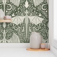 a green and white wallpaper with an intricate design on the side, next to two vases