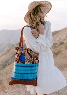 A show-stopping statement bag inspired by some of our favorite vintage designs. Our tie dye patchwork tote bag features a large tassel accent and a snap closure. FINAL SALE Mixed media patchwork Tie-dye Paisley Snap closure Large tassel accent Dimensions: 15" x 20"Style: DR-2105-2 Hippie Tote Bag For Daily Use, Bohemian Cotton Canvas Shoulder Bag, Bohemian Cotton Beach Bag For Travel, Hippie Cotton Bags For Everyday Use, Beach Tote Bag With Patchwork, Hippie Style Cotton Bags For Everyday, Beach Patchwork Tote Bag, Bohemian Cotton Shoulder Bag For Travel, Summer Travel Bag With Patchwork