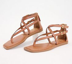 These strappy sandals are sure to show off your fashionista side. From Vince Camuto. Trendy Sandals With Adjustable Heel Strap, Trendy Adjustable Sandals With Heel Strap, Trendy Adjustable Strap Sandals, Trendy Open Toe T-strap Sandals For Spring, Spring Open Toe T-strap Sandals With Strap, Brown T-strap Footbed Sandals For Summer, Toe Post Strap Sandals For Spring, Spring Toe Post Sandals With Strap, Trendy Adjustable Ankle Strap Sandals