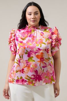 Show off your effortlessly sweet style in the Abigal Floral Brenna Mock Neck Ruffle Blouse! Our favorite blouse takes shape featuring a smocked, mock neck. Ruffle layered short sleeves steal the show while framing a relaxed bodice that can be styled tucked into your favorite high waisted bottoms.- Mock neck- Ruffle layer sleeves- Keyhole- Classic fit- Color: Coral MultiSize + Fit - Model is 5'10" and wearing size 2X- Measurements taken from size 2X - Chest: 49 1/2"- Length: 26 1/2" Fabric Self: Spring Flutter Sleeve Blouse With Smocked Back, Feminine Spring Blouse With Smocked Back, Chic Spring Smocked Top With Flutter Sleeves, Spring Blouse With Smocked Back And Flutter Sleeve, Chic Pink Blouse With Smocked Back, Feminine Stretch Blouse With Smocked Back, Feminine Ruffle Sleeve Blouse With Smocked Back, Feminine Blouse With Smocked Back And Ruffle Sleeves, Feminine Stretch Blouse With Smocked Bodice