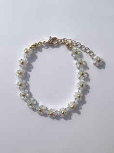 a bracelet with pearls and gold beads on a white surface, showing the bead ends